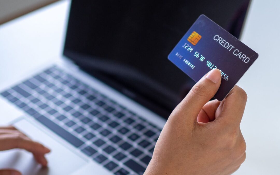 woman at laptop and credit card paying for abortion pill